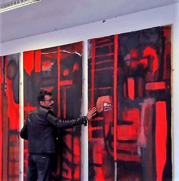 Mark with one of his abstract paintings.